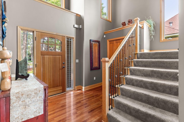 2334 Veterans Memorial Blvd NW, Andover, MN 55304 - foyer entrance featuring wood finished floors, stairs, healthy amount of natural light, and a high ceiling