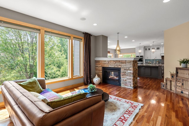 2334 Veterans Memorial Blvd NW, Andover, MN 55304 - living room featuring plenty of natural light, wood finished floors, recessed lighting, and a glass covered fireplace