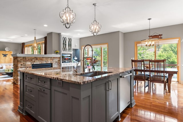 2334 Veterans Memorial Blvd NW, Andover, MN 55304 - kitchen with open floor plan, gray cabinetry, a chandelier, a center island with sink, and dark wood finished floors