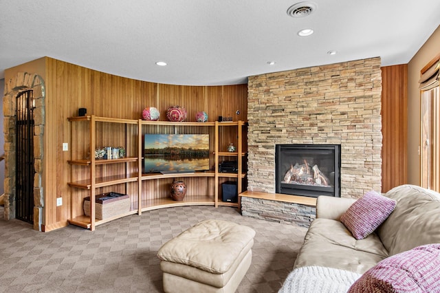 2334 Veterans Memorial Blvd NW, Andover, MN 55304 - carpeted living room with wooden walls, a fireplace, recessed lighting, and a textured ceiling