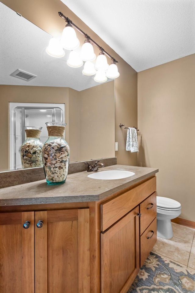 2334 Veterans Memorial Blvd NW, Andover, MN 55304 - bathroom featuring vanity, tile patterned flooring, a textured ceiling, and a shower with door