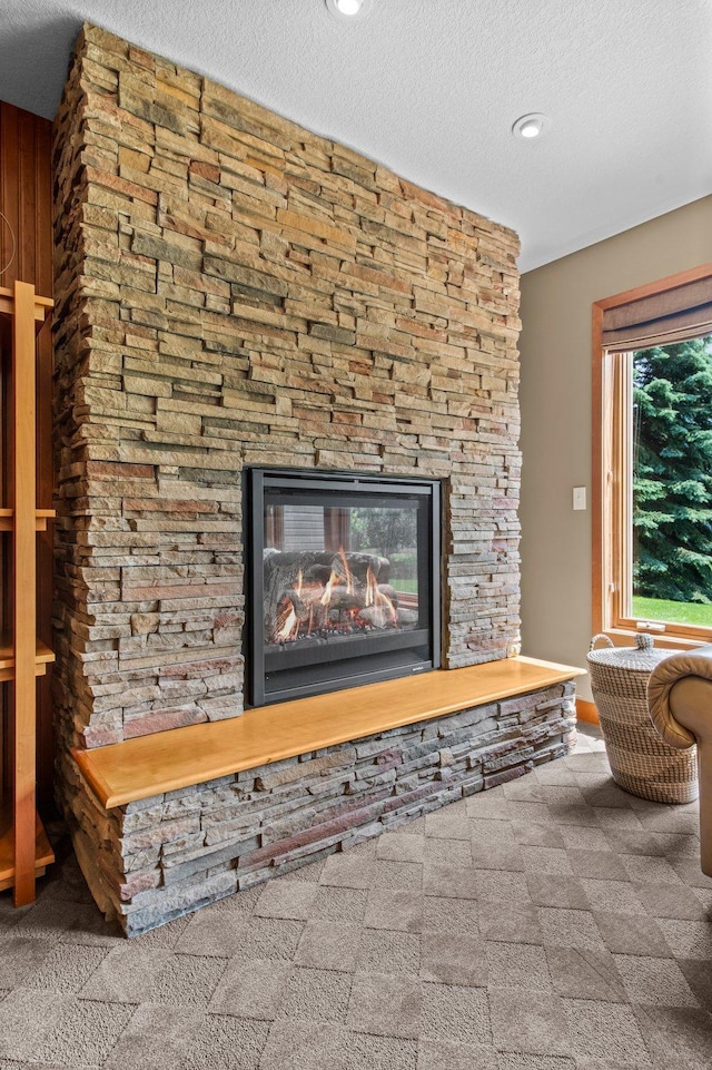 2334 Veterans Memorial Blvd NW, Andover, MN 55304 - detailed view of a stone fireplace, a textured ceiling, and recessed lighting