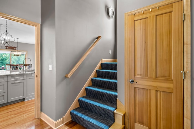 2334 Veterans Memorial Blvd NW, Andover, MN 55304 - staircase featuring a chandelier and wood finished floors