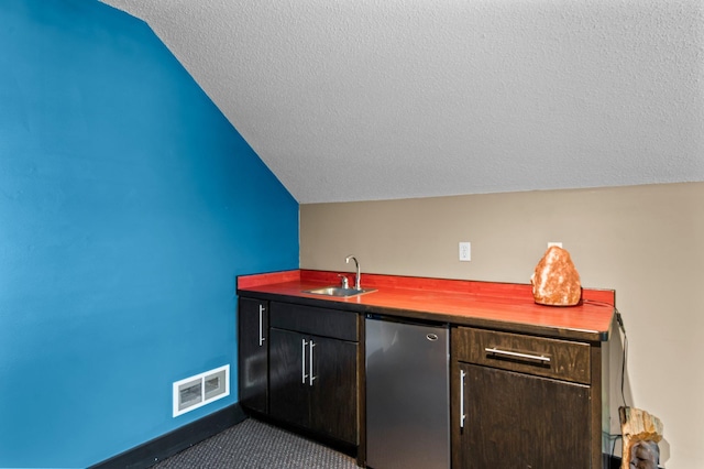 2334 Veterans Memorial Blvd NW, Andover, MN 55304 - indoor wet bar with refrigerator, vaulted ceiling, and a textured ceiling