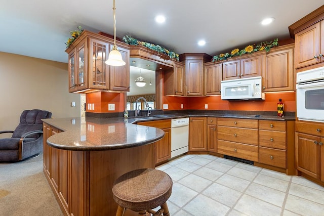 109 Pine Ave N, Canby, MN 56220 - kitchen with white appliances, brown cabinets, glass insert cabinets, and recessed lighting