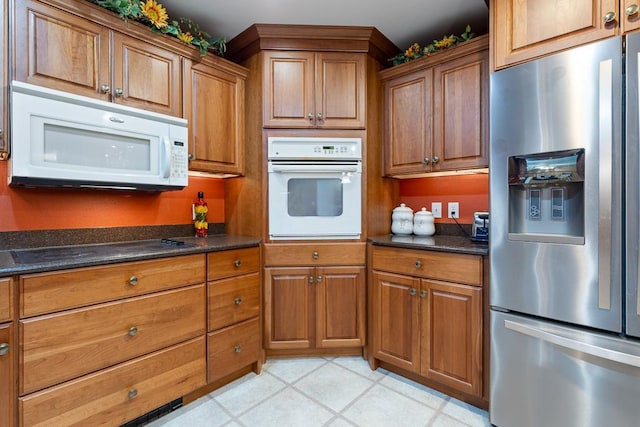 109 Pine Ave N, Canby, MN 56220 - kitchen featuring white appliances, brown cabinets, and dark stone counters