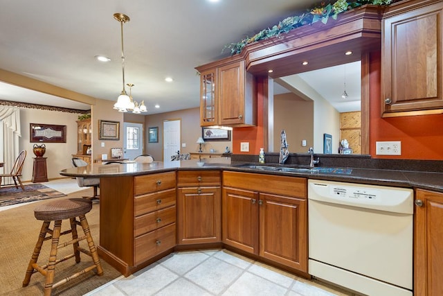 109 Pine Ave N, Canby, MN 56220 - kitchen featuring dishwasher, brown cabinets, a chandelier, a breakfast bar, and recessed lighting
