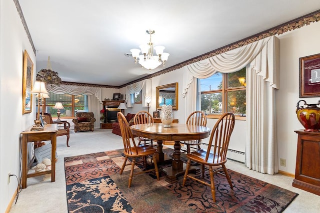 109 Pine Ave N, Canby, MN 56220 - dining space featuring a chandelier, light colored carpet, a fireplace, and ornamental molding