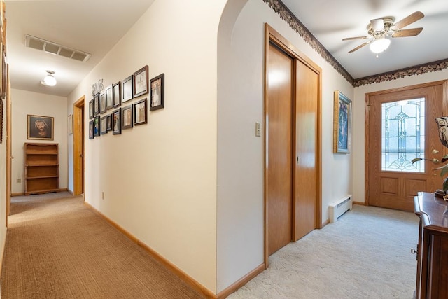 109 Pine Ave N, Canby, MN 56220 - corridor featuring light colored carpet, baseboard heating, and arched walkways