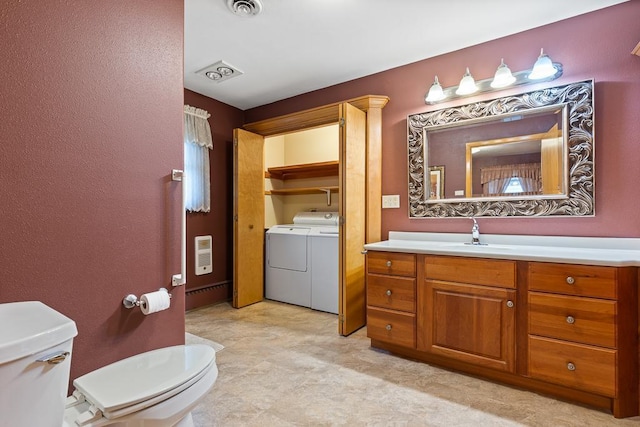 109 Pine Ave N, Canby, MN 56220 - bathroom with washing machine and dryer, vanity, and heating unit
