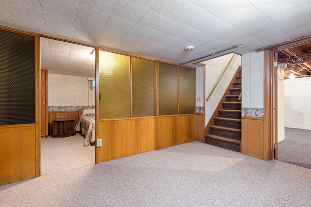 109 Pine Ave N, Canby, MN 56220 - finished basement with wooden walls, carpet floors, and stairway