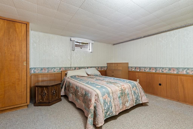 109 Pine Ave N, Canby, MN 56220 - bedroom featuring carpet, wood walls, wallpapered walls, and a wainscoted wall