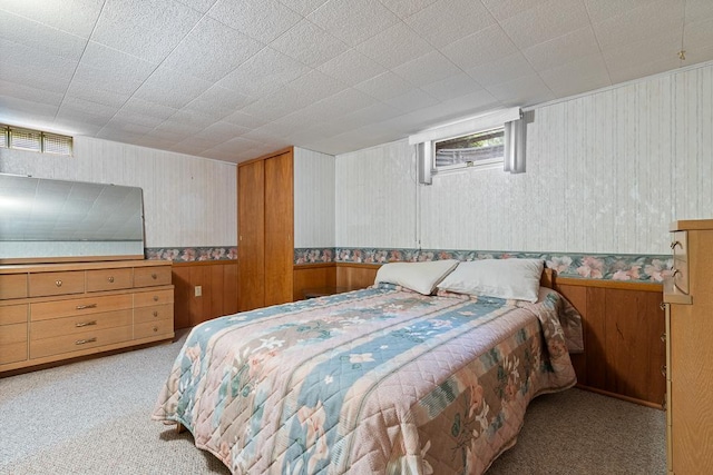 109 Pine Ave N, Canby, MN 56220 - bedroom with carpet floors, wooden walls, wallpapered walls, and wainscoting