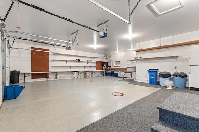 109 Pine Ave N, Canby, MN 56220 - garage featuring freestanding refrigerator and a garage door opener