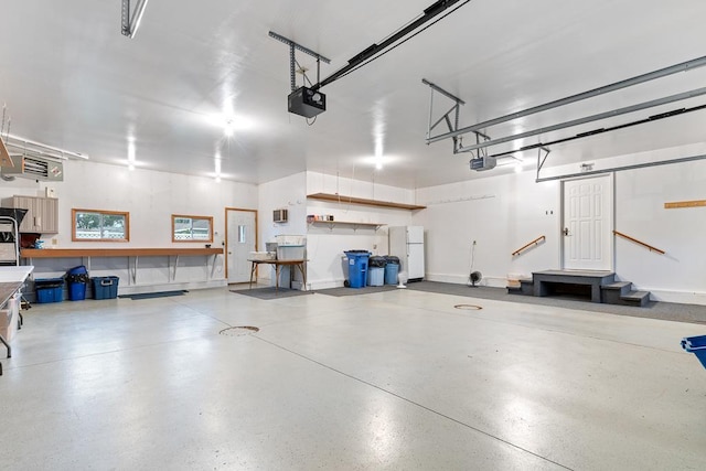 109 Pine Ave N, Canby, MN 56220 - garage featuring a garage door opener and freestanding refrigerator
