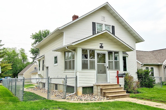 1936 5th St, Red Wing, MN 55066 - view of front of house with a chimney, a sunroom, and entry steps