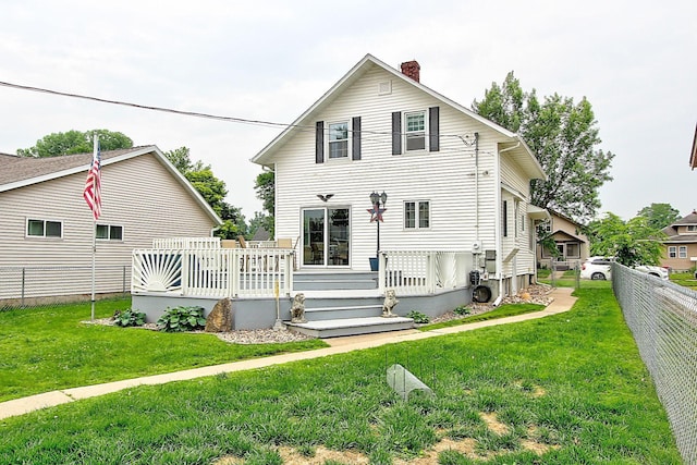 1936 5th St, Red Wing, MN 55066 - view of front of home with a chimney, a fenced backyard, and a deck