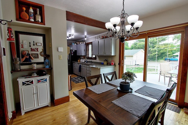 1936 5th St, Red Wing, MN 55066 - dining room with light wood-style floors and a chandelier