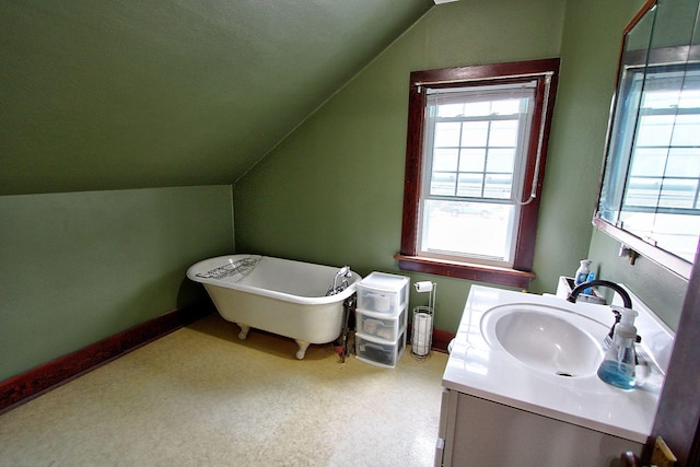 1936 5th St, Red Wing, MN 55066 - full bathroom featuring vanity, lofted ceiling, and a freestanding bath