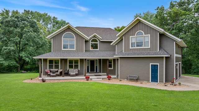 18505 210th Ave NE, Paynesville, MN 56362 - rear view of property featuring a porch, board and batten siding, roof with shingles, a lawn, and an outdoor living space