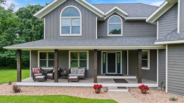 18505 210th Ave NE, Paynesville, MN 56362 - view of front of property featuring a porch, roof with shingles, and board and batten siding