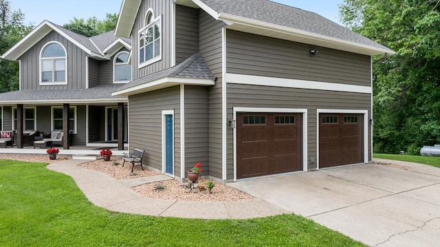 18505 210th Ave NE, Paynesville, MN 56362 - view of side of home with an attached garage, covered porch, driveway, a shingled roof, and board and batten siding