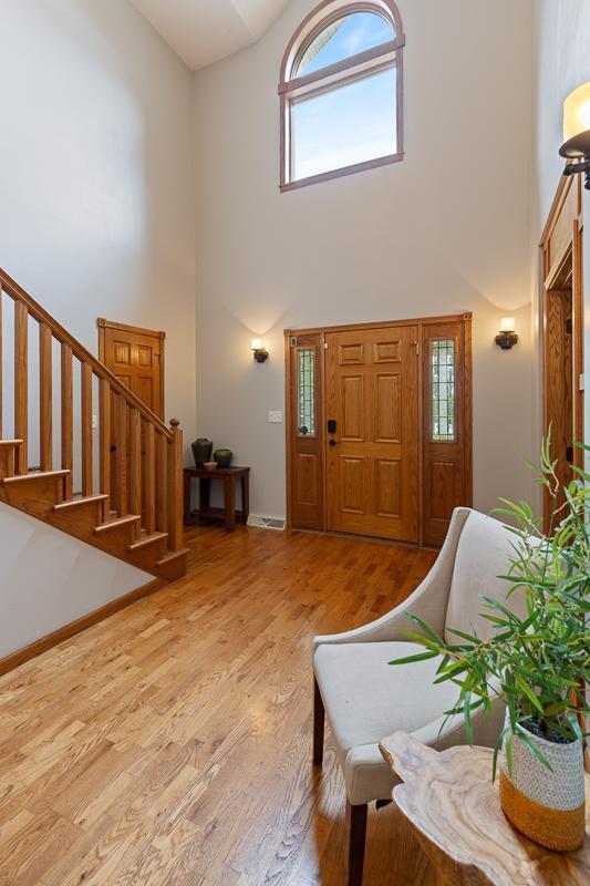 18505 210th Ave NE, Paynesville, MN 56362 - entrance foyer featuring a high ceiling, wood finished floors, and stairway