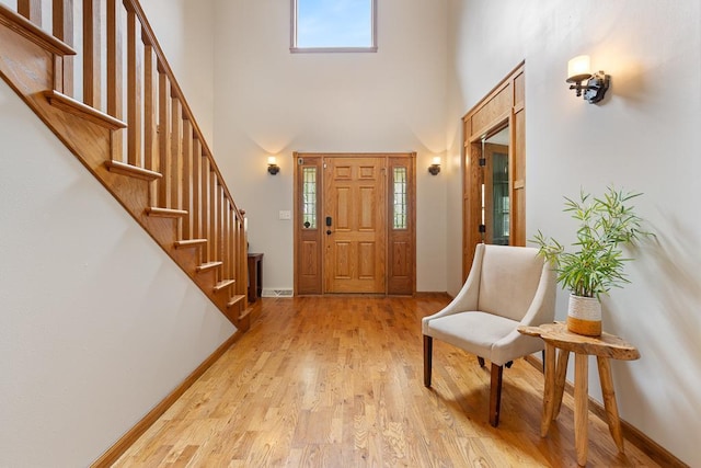 18505 210th Ave NE, Paynesville, MN 56362 - entrance foyer featuring a towering ceiling, light wood finished floors, and stairs