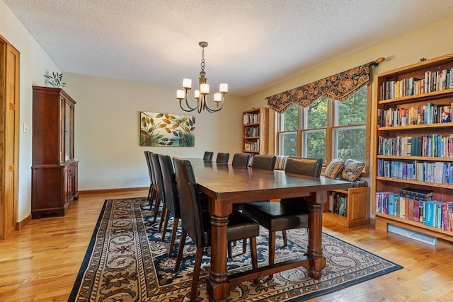 18505 210th Ave NE, Paynesville, MN 56362 - dining room featuring a chandelier, light wood-style floors, and a textured ceiling