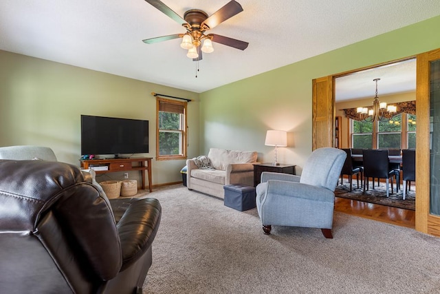18505 210th Ave NE, Paynesville, MN 56362 - carpeted living room featuring a chandelier, ceiling fan, and healthy amount of natural light