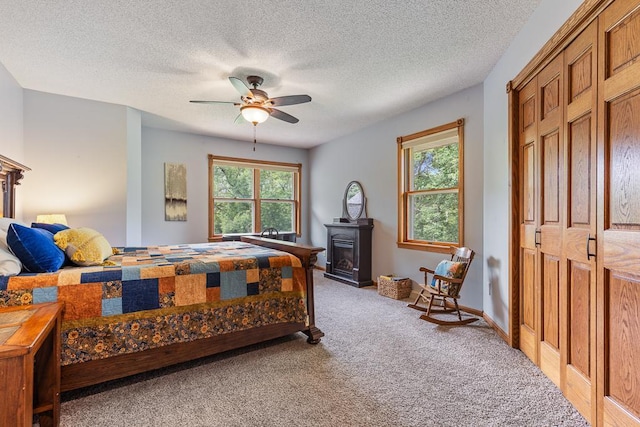 18505 210th Ave NE, Paynesville, MN 56362 - bedroom featuring light colored carpet, multiple windows, a textured ceiling, and a ceiling fan