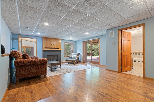 18505 210th Ave NE, Paynesville, MN 56362 - living room featuring hardwood / wood-style flooring, a fireplace, a drop ceiling, and recessed lighting
