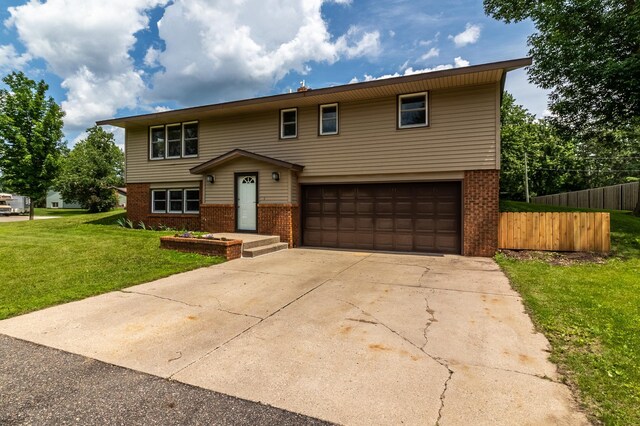1744 Oak Rd, Saint Cloud, MN 56303 - view of front of house featuring brick siding, an attached garage, and concrete driveway