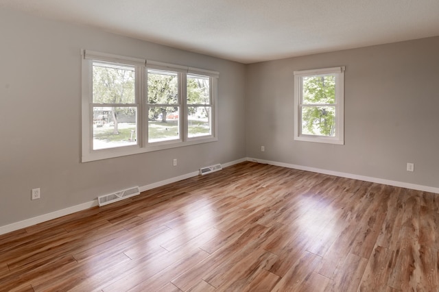 1744 Oak Rd, Saint Cloud, MN 56303 - empty room with healthy amount of natural light and wood finished floors