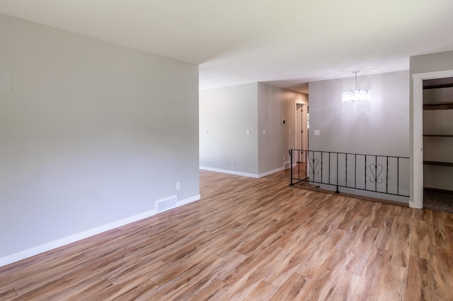 1744 Oak Rd, Saint Cloud, MN 56303 - spare room featuring light wood-type flooring and a chandelier
