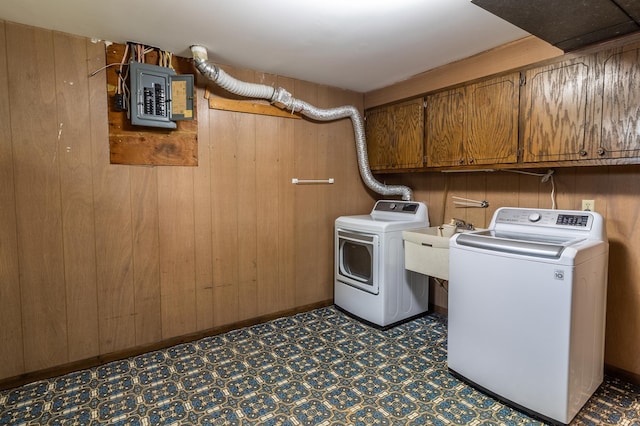 1744 Oak Rd, Saint Cloud, MN 56303 - washroom with cabinet space, electric panel, separate washer and dryer, wooden walls, and tile patterned floors