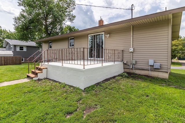 1744 Oak Rd, Saint Cloud, MN 56303 - rear view of house with a chimney and a lawn