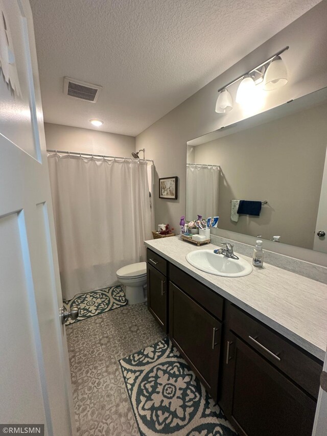 1004 Triumph Trl NE, Isanti, MN 55040 - bathroom featuring vanity, a textured ceiling, and a shower with shower curtain