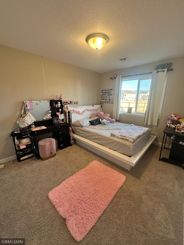 1004 Triumph Trl NE, Isanti, MN 55040 - carpeted bedroom with a textured ceiling