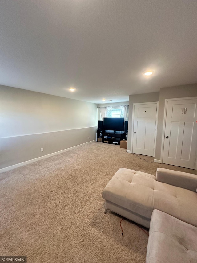 1004 Triumph Trl NE, Isanti, MN 55040 - carpeted living area with baseboards and recessed lighting