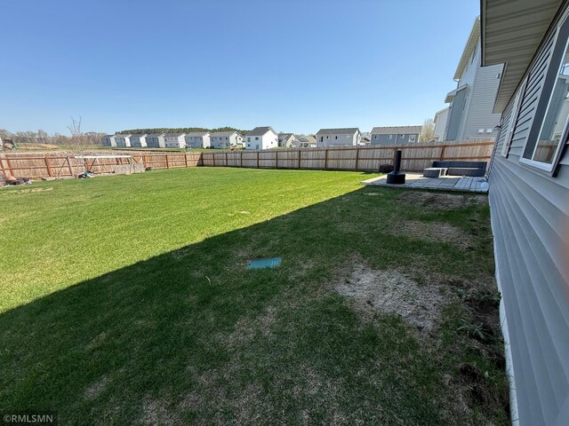 1004 Triumph Trl NE, Isanti, MN 55040 - fenced backyard with a patio and a residential view