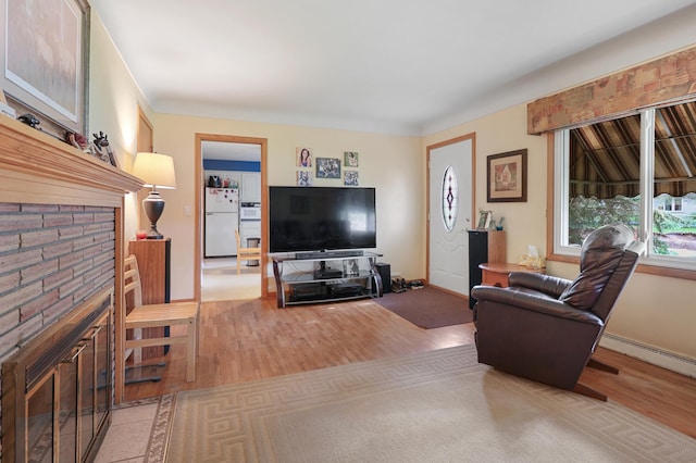 842 28th Ave N, Saint Cloud, MN 56303 - living room with wood finished floors, baseboard heating, and a glass covered fireplace