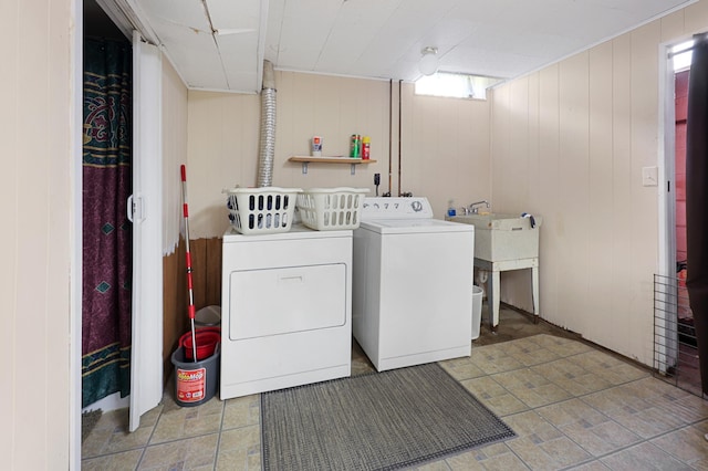 842 28th Ave N, Saint Cloud, MN 56303 - laundry area with washer and clothes dryer, tile patterned floors, and wood walls