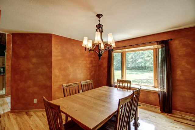 22896 Anchor Dr, Menahga, MN 56464 - dining space featuring a chandelier and light wood-type flooring