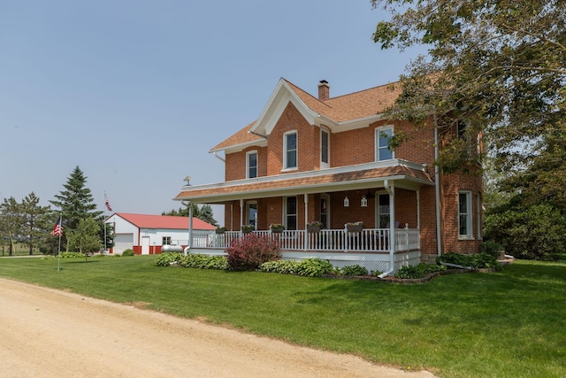 10706 65th Ave SE, Stewartville, MN 55976 - view of front of property featuring a porch, brick siding, a chimney, and a front lawn