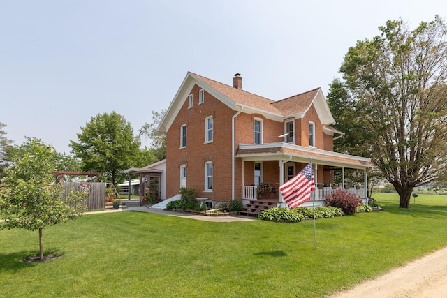 10706 65th Ave SE, Stewartville, MN 55976 - view of front of home featuring covered porch, brick siding, and a chimney
