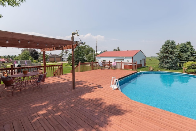 10706 65th Ave SE, Stewartville, MN 55976 - swimming pool featuring a wooden deck, a lawn, an outdoor structure, and outdoor dining area