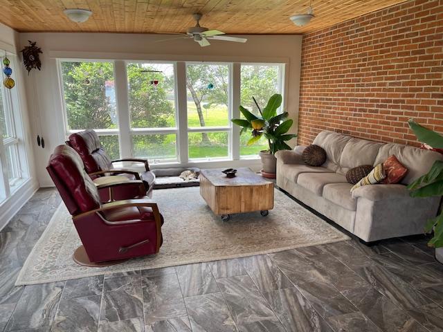 10706 65th Ave SE, Stewartville, MN 55976 - living area with wooden ceiling, healthy amount of natural light, brick wall, and a ceiling fan