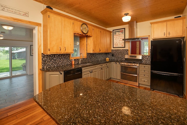 10706 65th Ave SE, Stewartville, MN 55976 - kitchen featuring freestanding refrigerator, wall chimney exhaust hood, double oven range, dishwashing machine, and tasteful backsplash