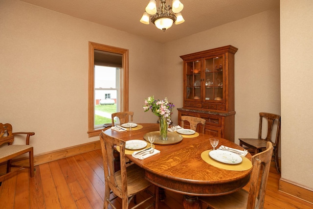 10706 65th Ave SE, Stewartville, MN 55976 - dining space featuring light wood finished floors and a chandelier